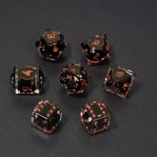 Set of 7 lit Clear dice with a rainbow of colors across all faces. Set Includes: 1 D20, 1 D12, 1 D10, 1 D8, 2 Pipped D6, 1 D4. Clear colorway is fully transparent resin allowing internal circuit board to be visible. The numbers or symbols are painted metallic copper.