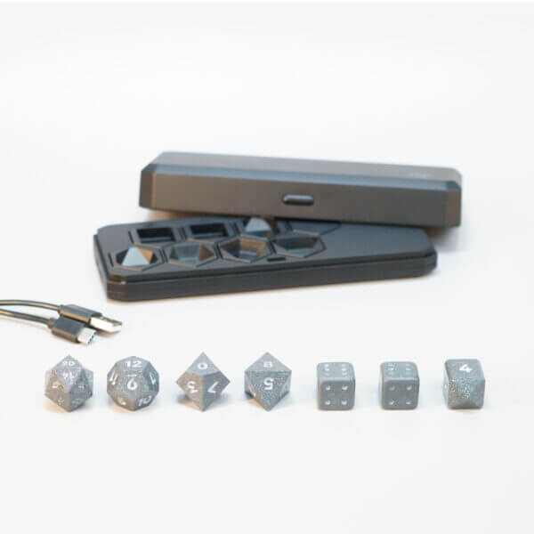 Set of 7 lit Hematite Grey dice with a rainbow of colors across all faces. Set Includes: 1 D20, 1 D12, 1 D10, 1 D8, 2 Pipped D6, 1 D4. Hematite Grey colorway is a fully opaque medium tone silver resin packed with rainbow glitter of various sizes. The numbers or symbols are painted pale white.