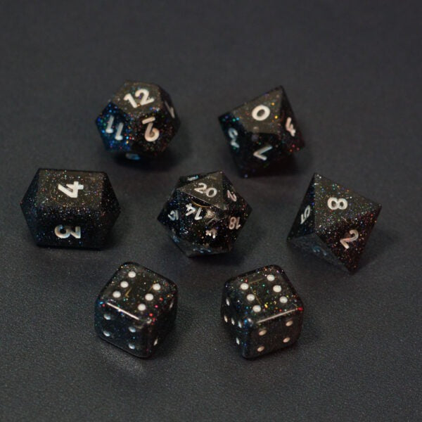 Set of 7 lit Midnight Galaxy dice with a rainbow of colors across all faces. Set Includes: 1 D20, 1 D12, 1 D10, 1 D8, 2 Pipped D6, 1 D4. Midnight Galaxy colorway is a mostly translucent dark smoke black resin base packed with rainbow glitter of various sizes. The numbers or symbols are painted pearl white.