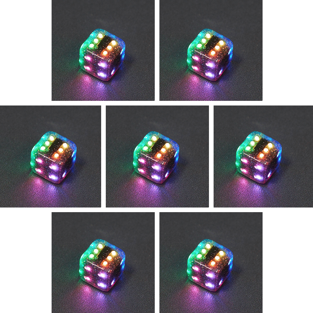 Collage of 7 lit Midnight Galaxy Pipped D6 with a rainbow of colors across each face. Midnight Galaxy colorway is a mostly translucent dark smoke black resin base packed with rainbow glitter of various sizes. The numbers or symbols are painted pearl white.