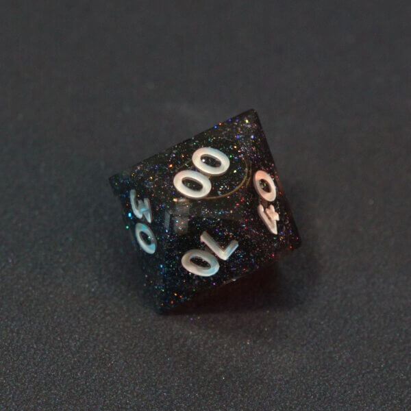 Collage of 7 lit Midnight Galaxy D00 with a rainbow of colors across each face. Midnight Galaxy colorway is a mostly translucent dark smoke black resin base packed with rainbow glitter of various sizes. The numbers or symbols are painted pearl white.