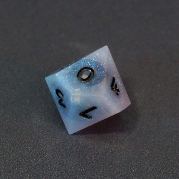 Collage of 7 lit Aurora Sky D10 with a rainbow of colors across each face. Aurora Sky colorway is a mostly translucent white resin base packed with small blue and silver glitter throughout. The numbers or symbols are painted metallic black.