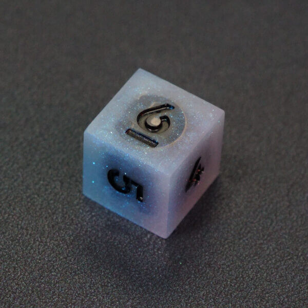 Collage of 7 lit Aurora Sky D6 with a rainbow of colors across each face. Aurora Sky colorway is a mostly translucent white resin base packed with small blue and silver glitter throughout. The numbers or symbols are painted metallic black.