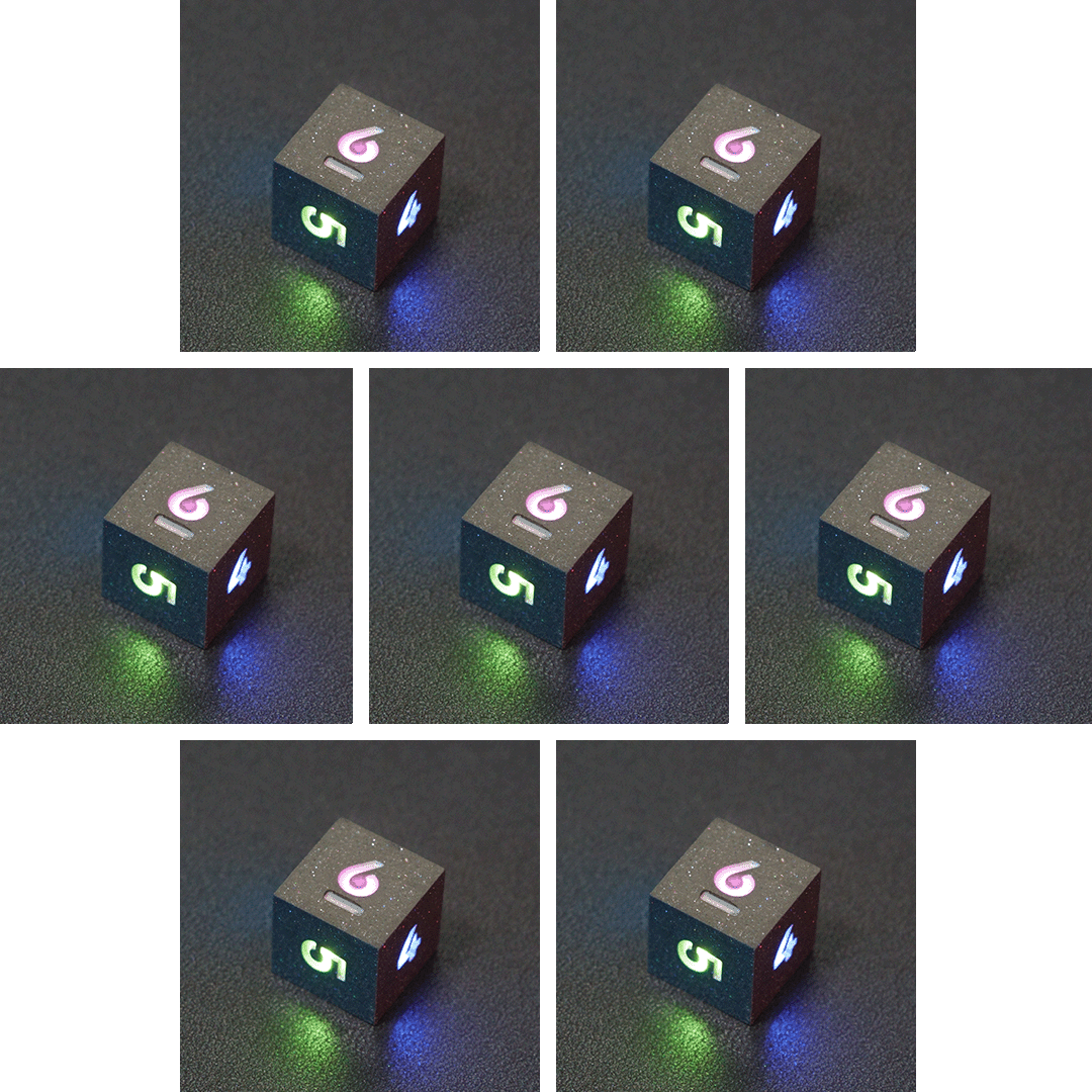 Collage of 7 lit Hematite Grey D6 with a rainbow of colors across each face. Hematite Grey colorway is a fully opaque medium tone silver resin packed with rainbow glitter of various sizes. The numbers or symbols are painted pale white.