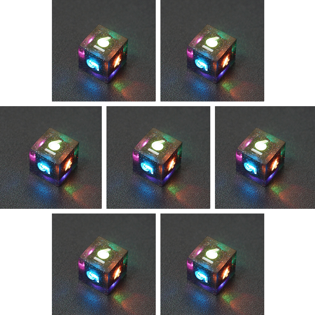 Collage of 7 lit Midnight Galaxy D6 with a rainbow of colors across each face. Midnight Galaxy colorway is a mostly translucent dark smoke black resin base packed with rainbow glitter of various sizes. The numbers or symbols are painted pearl white.