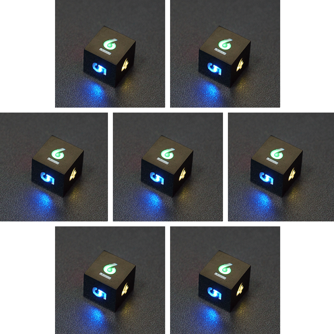 Collage of 7 lit Onyx Black D6 with a rainbow of colors across each face. Onyx Black colorway is a fully opaque black with no glitter, creating an almost matte style. The numbers or symbols are pale white.