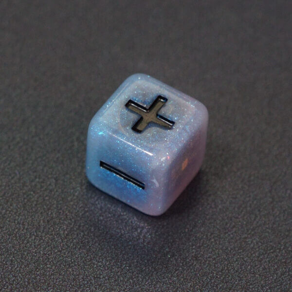 Collage of 7 lit Aurora Sky Fudge D6 with a rainbow of colors across each face. Aurora Sky colorway is a mostly translucent white resin base packed with small blue and silver glitter throughout. The numbers or symbols are painted metallic black.