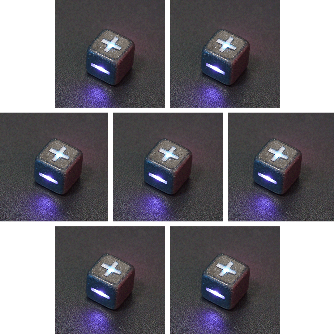 Collage of 7 lit Hematite Grey Fudge D6 with a rainbow of colors across each face. Hematite Grey colorway is a fully opaque medium tone silver resin packed with rainbow glitter of various sizes. The numbers or symbols are painted pale white.