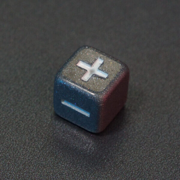 Collage of 7 lit Hematite Grey Fudge D6 with a rainbow of colors across each face. Hematite Grey colorway is a fully opaque medium tone silver resin packed with rainbow glitter of various sizes. The numbers or symbols are painted pale white.