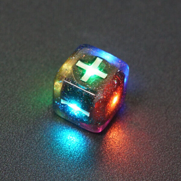 Collage of 7 lit Midnight Galaxy Fudge D6 with a rainbow of colors across each face. Midnight Galaxy colorway is a mostly translucent dark smoke black resin base packed with rainbow glitter of various sizes. The numbers or symbols are painted pearl white.