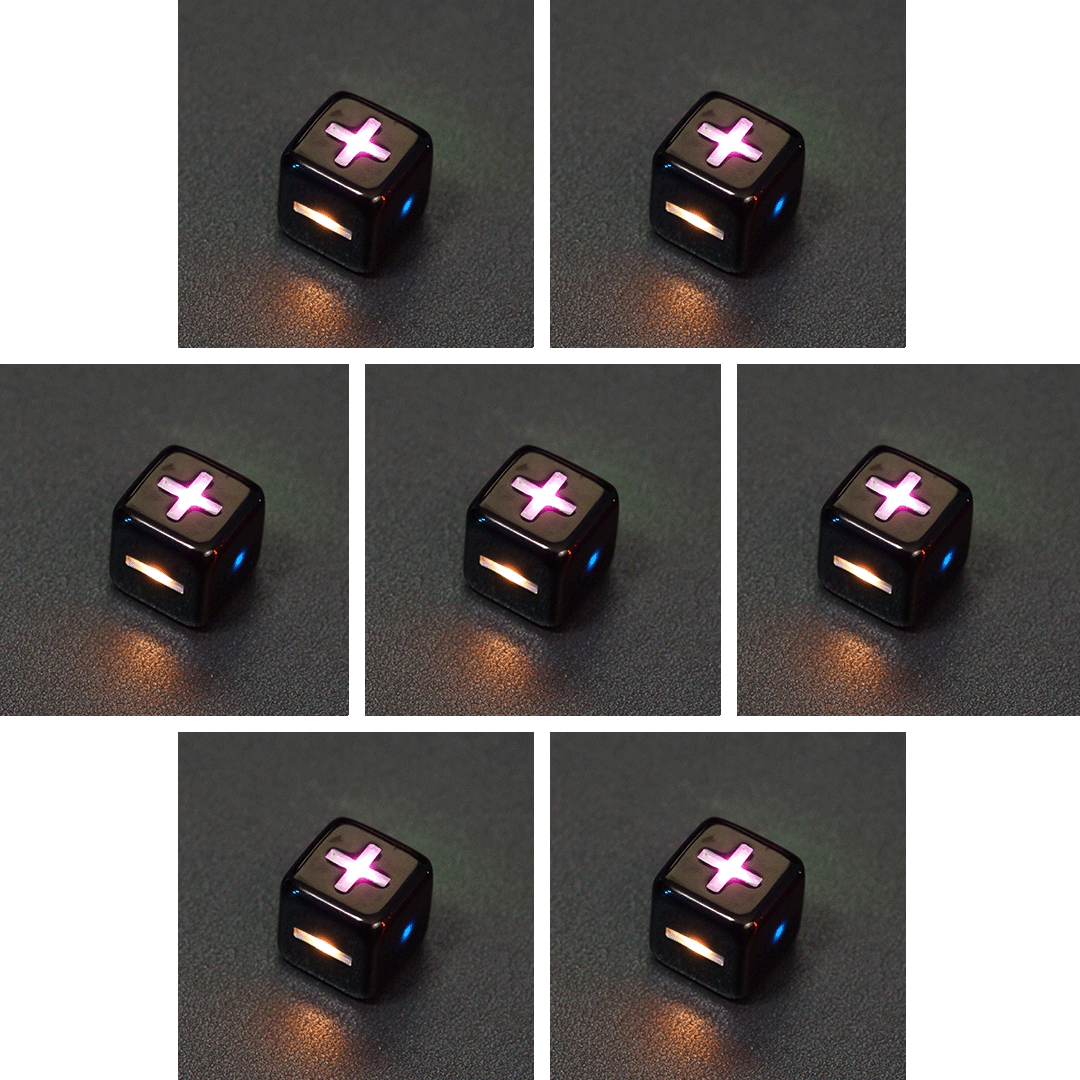 Collage of 7 lit Onyx Black Fudge D6 with a rainbow of colors across each face. Onyx Black colorway is a fully opaque black with no glitter, creating an almost matte style. The numbers or symbols are pale white.