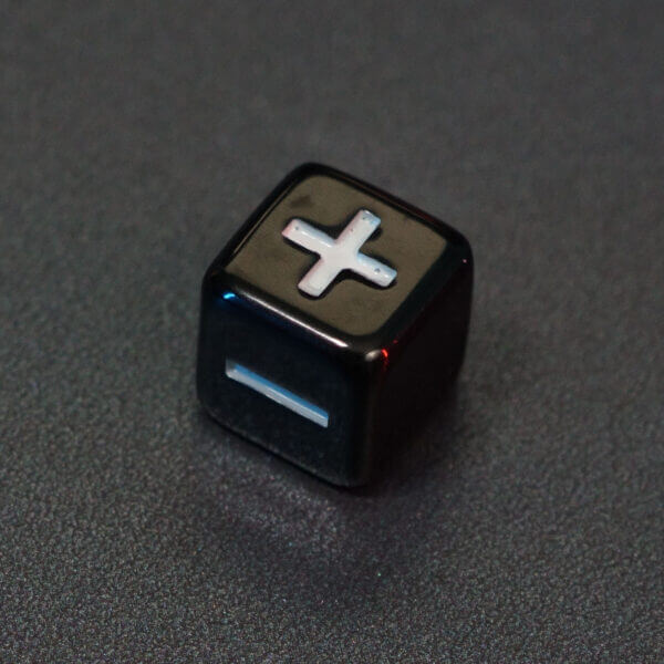 Collage of 7 lit Onyx Black Fudge D6 with a rainbow of colors across each face. Onyx Black colorway is a fully opaque black with no glitter, creating an almost matte style. The numbers or symbols are pale white.