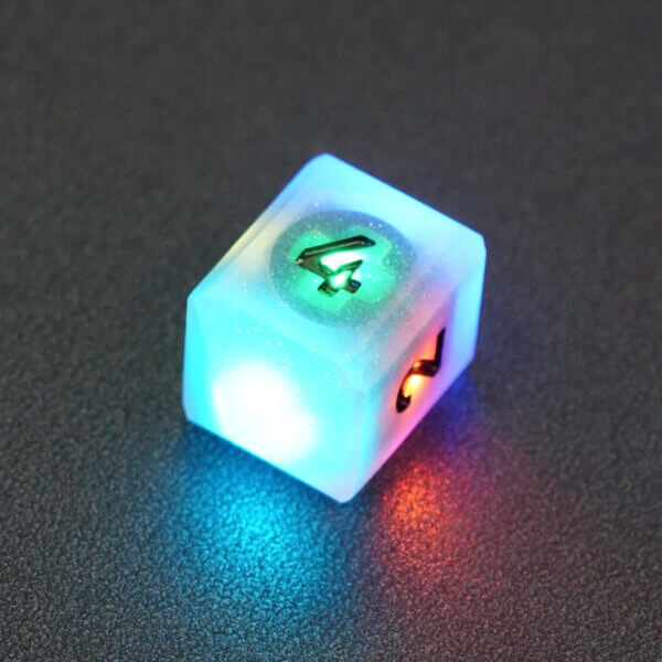 Collage of 7 lit Aurora Sky D4 in a crystal shape with a rainbow of colors across each face. Aurora Sky colorway is a mostly translucent white resin base packed with small blue and silver glitter throughout. The numbers or symbols are painted metallic black.