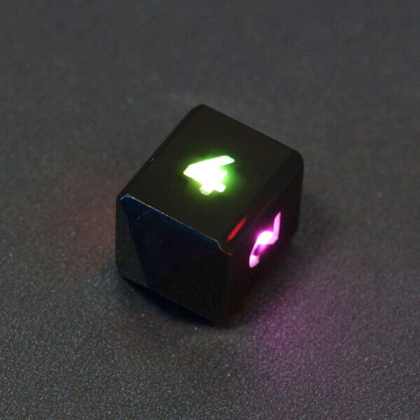 Collage of 7 lit Onyx Black D4 in a crystal shape with a rainbow of colors across each face. Onyx Black colorway is a fully opaque black with no glitter, creating an almost matte style. The numbers or symbols are pale white.