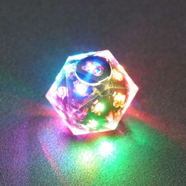 Collage of 7 lit Clear D20 with a rainbow of colors across each face. Clear colorway is fully transparent resin allowing internal circuit board to be visible. The numbers or symbols are painted metallic copper.