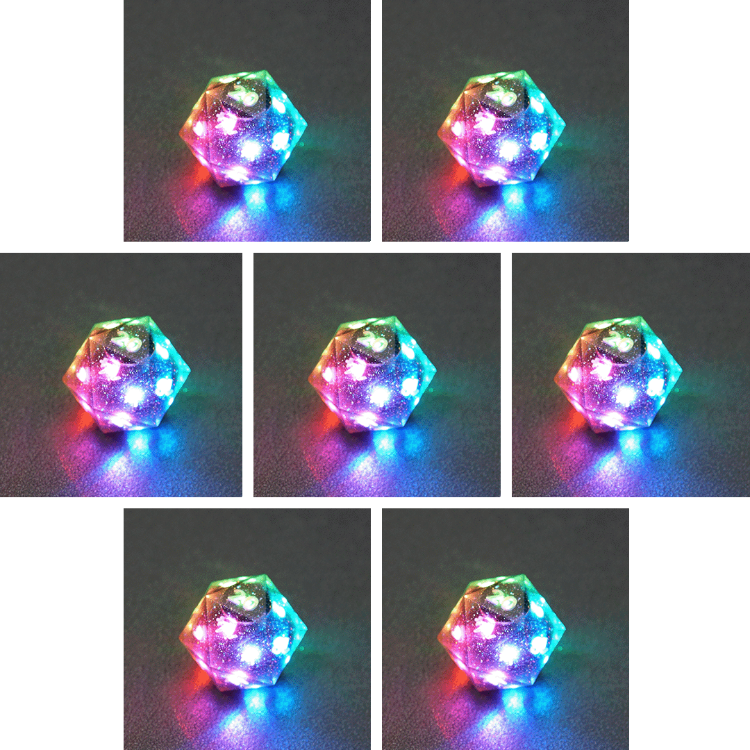 Collage of 7 lit Midnight Galaxy D20 with a rainbow of colors across each face. Midnight Galaxy colorway is a mostly translucent dark smoke black resin base packed with rainbow glitter of various sizes. The numbers or symbols are painted pearl white.