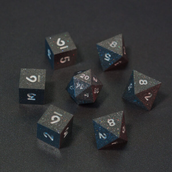 Set of 7 lit Hematite Grey dice with a rainbow of colors across all faces. Set Includes: 1 D20, 3 D8, 3 D6. Hematite Grey colorway is a fully opaque medium tone silver resin packed with rainbow glitter of various sizes. The numbers or symbols are painted pale white.
