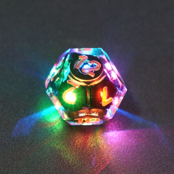 Collage of 7 lit Clear D12 with a rainbow of colors across each face. Clear colorway is fully transparent resin allowing internal circuit board to be visible. The numbers or symbols are painted metallic copper.