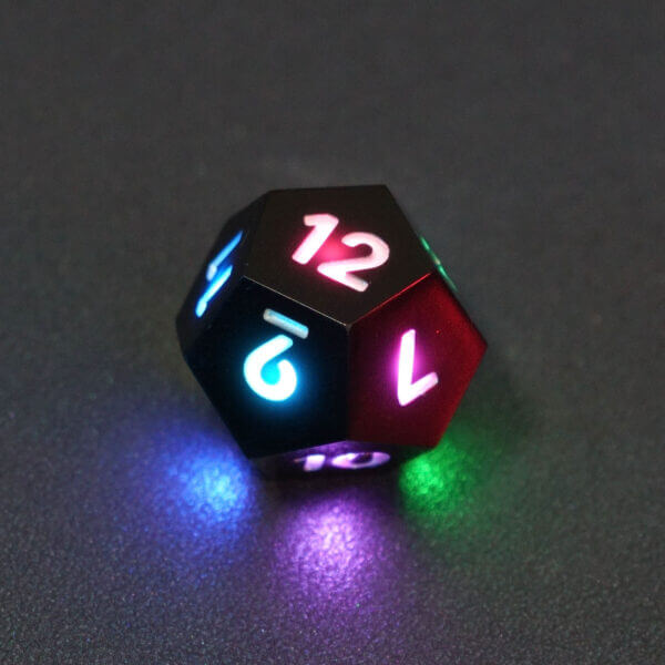Collage of 7 lit Onyx Black D12 with a rainbow of colors across each face. Onyx Black colorway is a fully opaque black with no glitter, creating an almost matte style. The numbers or symbols are pale white.