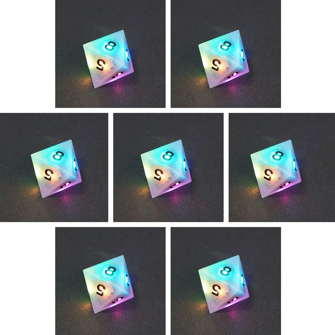 Collage of 7 lit Aurora Sky D8 with a rainbow of colors across each face. Aurora Sky colorway is a mostly translucent white resin base packed with small blue and silver glitter throughout. The numbers or symbols are painted metallic black.