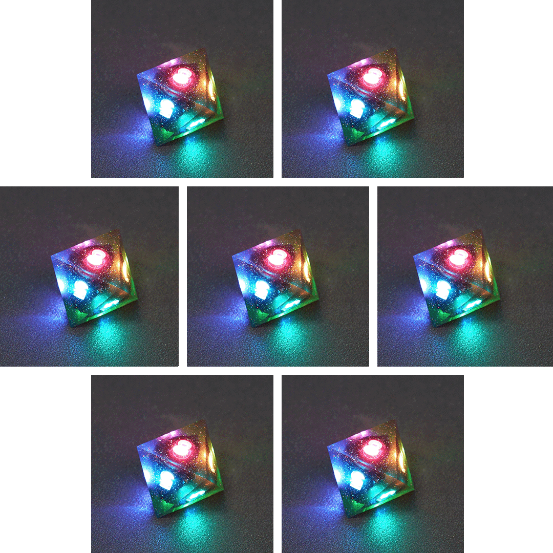 Collage of 7 lit Midnight Galaxy D8 with a rainbow of colors across each face. Midnight Galaxy colorway is a mostly translucent dark smoke black resin base packed with rainbow glitter of various sizes. The numbers or symbols are painted pearl white.