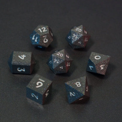 Set of 7 lit Hematite Grey dice with a rainbow of colors across all faces. Set Includes: 2 D20, 1 D12, 1 D10, 1 D8, 1 D6, 1 D4. Hematite Grey colorway is a fully opaque medium tone silver resin packed with rainbow glitter of various sizes. The numbers or symbols are painted pale white.