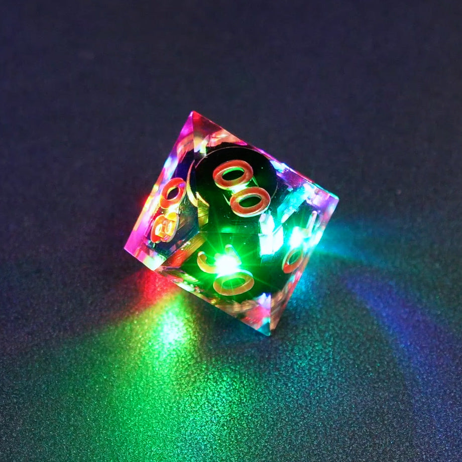 Lit Clear D00 with a rainbow of colors across each face. Clear colorway is fully transparent resin allowing internal circuit board to be visible. The numbers or symbols are painted metallic copper.