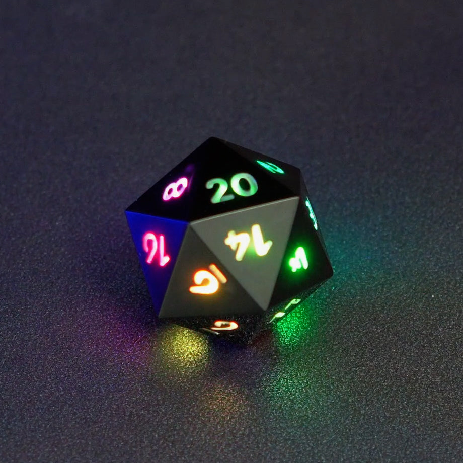 Lit Onyx Black D20 with a rainbow of colors across each face. Onyx Black colorway is a fully opaque black resin with no glitter. The numbers or symbols are painted pale white.