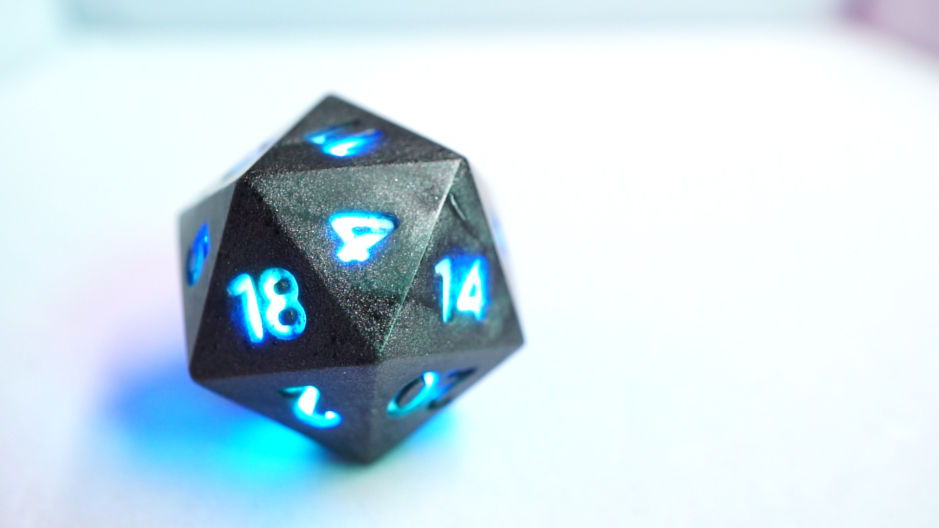 Gray D20 with numbers lit blue.