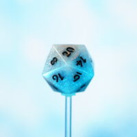 Unlit Aurora Sky D20 on a blue background. Aurora Sky colorway is a mostly translucent white resin base packed with small blue and silver glitter throughout. The numbers or symbols are painted metallic black.