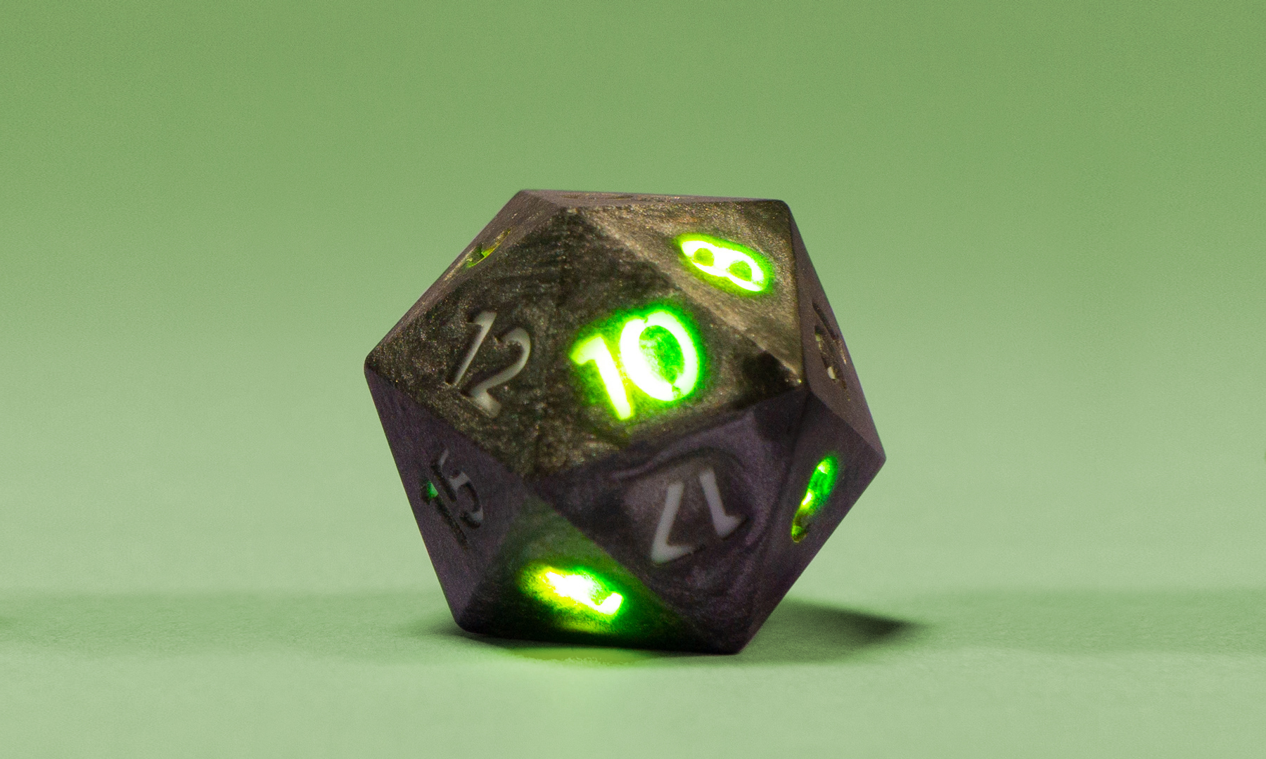 D20 lit with green numbers.