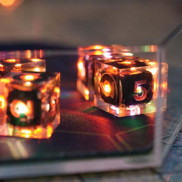 Lit Clear D6s viewed through the side of a clear acrylic dice tray.