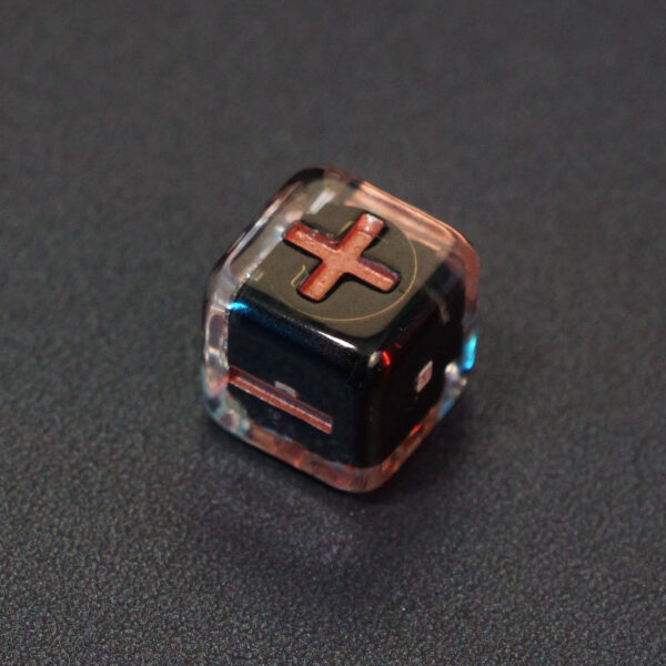 Unlit Clear Fudge D6. Clear colorway is fully transparent resin allowing internal circuit board to be visible. The numbers or symbols are painted metallic copper.