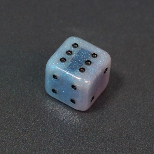 Unlit Aurora Sky Pipped D6. Aurora Sky colorway is a mostly translucent white resin base packed with small blue and silver glitter throughout. The numbers or symbols are painted metallic black.