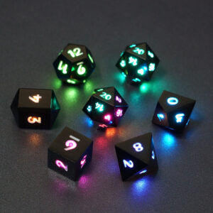 Set of 7 lit Onyx Black dice with a rainbow of colors across all faces. Set Includes: 2 D20, 1 D12, 1 D10, 1 D8, 1 D6, 1 D4. Onyx Black colorway is a fully opaque black resin with no glitter. The numbers or symbols are painted pale white.