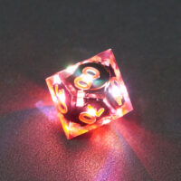 Lit Clear D00 with red colors across each face. Clear colorway is fully transparent resin allowing internal circuit board to be visible. The numbers or symbols are painted metallic copper.