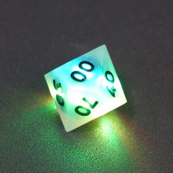 Lit Aurora Sky D00 with blue and green colors across each face. Aurora Sky colorway is a mostly translucent white resin base packed with small blue and silver glitter throughout. The numbers or symbols are painted metallic black.