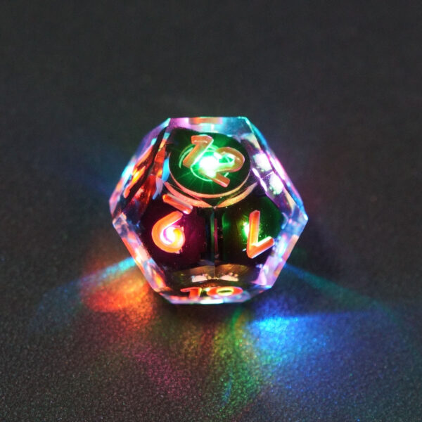 Lit Clear D12 with a rainbow of colors across each face. Clear colorway is fully transparent resin allowing internal circuit board to be visible. The numbers or symbols are painted metallic copper.