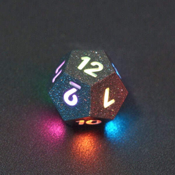 Lit Hematite Grey D12 with a rainbow of colors across each face. Hematite Grey colorway is a fully opaque medium tone silver resin packed with rainbow glitter of various sizes. The numbers or symbols are painted pale white.