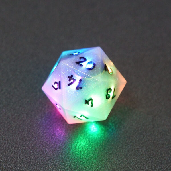 Lit Aurora Sky D20 with a rainbow of colors across each face. Aurora Sky colorway is a mostly translucent white resin base packed with small blue and silver glitter throughout. The numbers or symbols are painted metallic black.