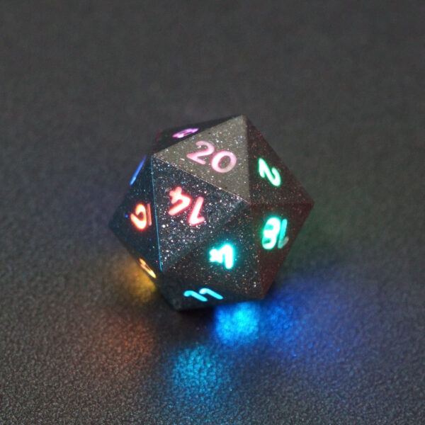 Lit Hematite Grey D20 with a rainbow of colors across each face. Hematite Grey colorway is a fully opaque medium tone silver resin packed with rainbow glitter of various sizes. The numbers or symbols are painted pale white.