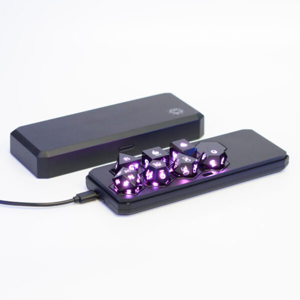 Lit Onyx Black RPG set placed inside a Large Charging Case with a USB cable plugged into the side of the case.