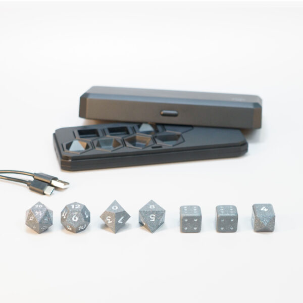 Unlit Hematite Grey Board Gamer set lined up in front of a Large Charging Case and USB Cable.