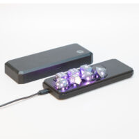 Lit Hematite Gray Board Gamer set placed inside a Large Charging Case with a USB cable plugged into the side of the case.