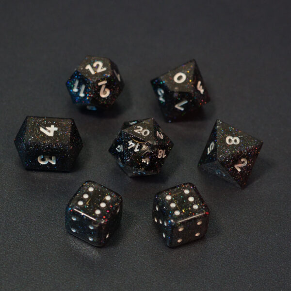 Set of 7 unlit Midnight Galaxy dice. Set Includes: 1 D20, 1 D12, 1 D10, 1 D8, 2 Pipped D6, 1 D4. Midnight Galaxy colorway is a mostly translucent dark smoke black resin base packed with rainbow glitter of various sizes. The numbers or symbols are painted pearl white.