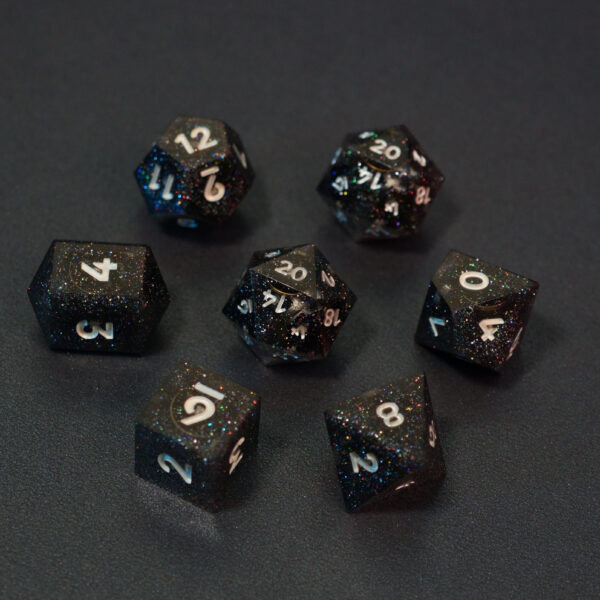 Set of 7 unlit Midnight Galaxy dice. Set Includes: 2 D20, 1 D12, 1 D10, 1 D8, 1 D6, 1 D4. Midnight Galaxy colorway is a mostly translucent dark smoke black resin base packed with rainbow glitter of various sizes. The numbers or symbols are painted pearl white.