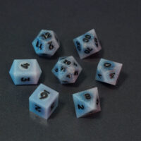 Set of 7 unlit Aurora Sky dice. Set Includes: 1 D20, 1 D12, 1 D00, 1 D10, 1 D8, 1 D6, 1 D4. Aurora Sky colorway is a mostly translucent white resin base packed with small blue and silver glitter throughout. The numbers or symbols are painted metallic black.
