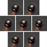 Collage of 7 lit Onyx Black Fudge D6 with a rainbow of colors across each face. Onyx Black colorway is a fully opaque black with no glitter, creating an almost matte style. The numbers or symbols are pale white.