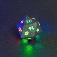 Lit Hematite Grey D20 with a rainbow of colors across each face. Hematite Grey colorway is a fully opaque medium tone silver resin packed with rainbow glitter of various sizes. The numbers or symbols are painted pale white.