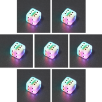 Collage of 7 lit Aurora Sky Pipped D6 with a rainbow of colors across each face. Aurora Sky colorway is a mostly translucent white resin base packed with small blue and silver glitter throughout. The numbers or symbols are painted metallic black.